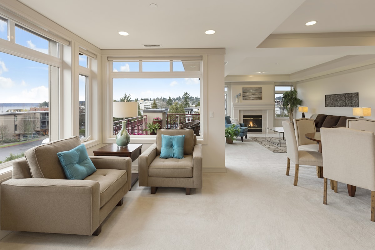 Light-filled open-plan living room with comfortable armchairs (stock photo — replace with a real photo of this home).